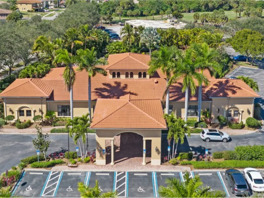 Aerial view of the clubhouse and pool at Valencia Golf & Country Club in Naples, Florida